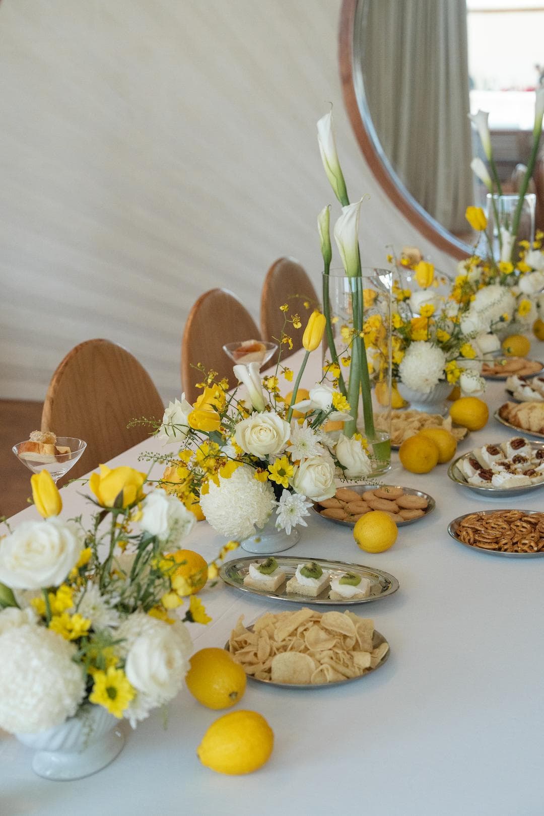 A bright table set with lemons and white flowers.
