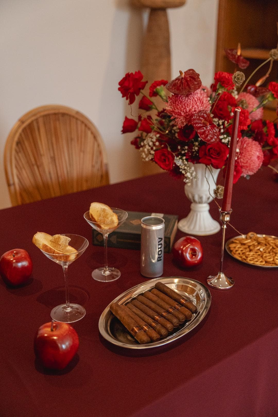 The table dressed for a Rouv evening — cocktails, flowers, and something to share.