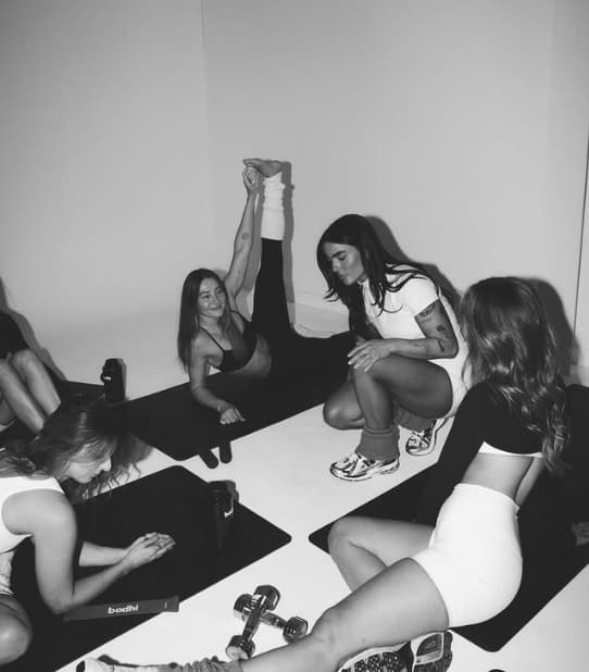 A host guiding a small group through a session in the studio.